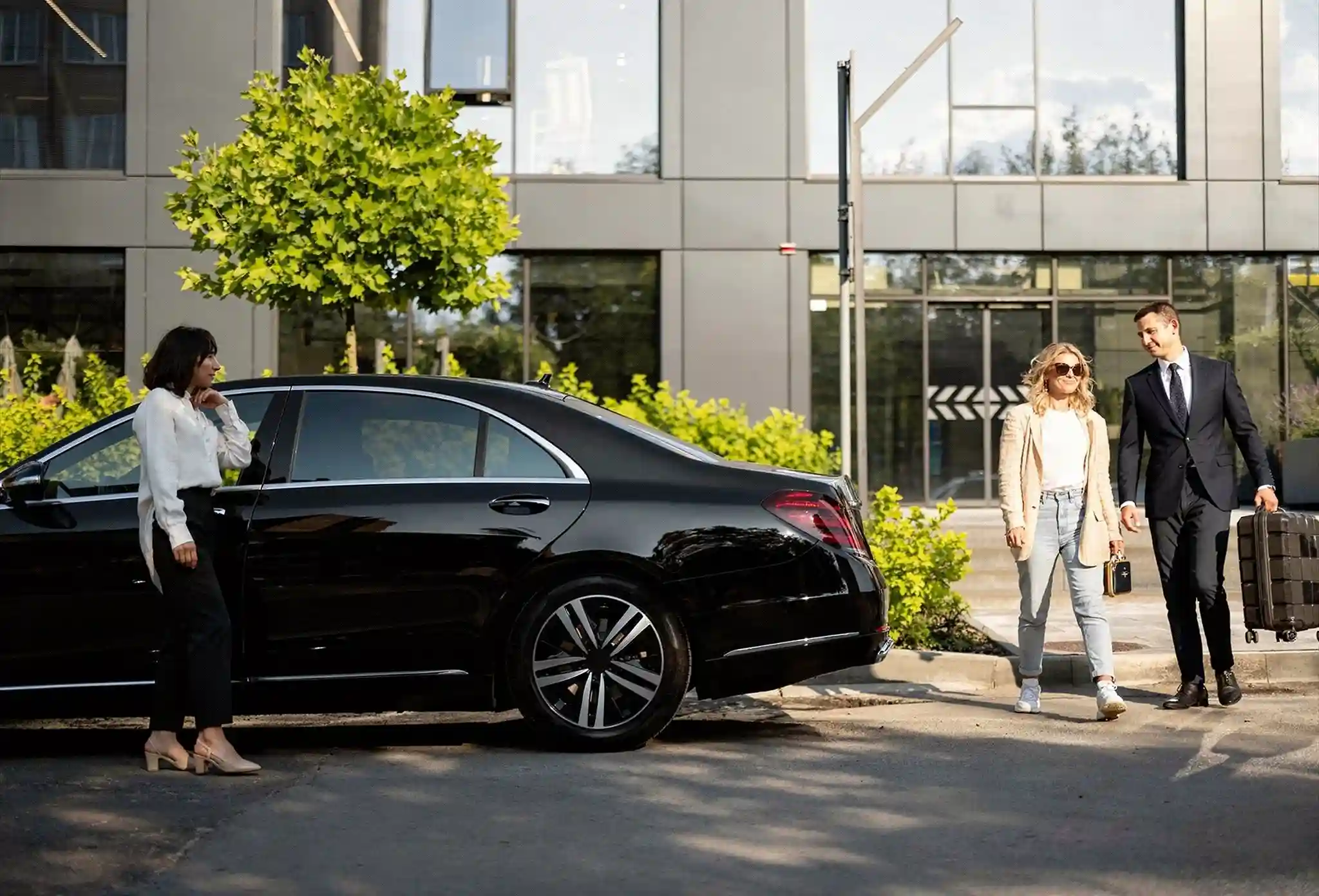 Professional luxury chauffeur opening car door in London